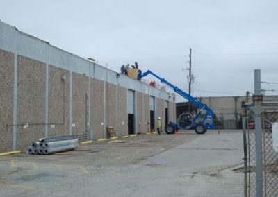 A crane lifting products on to the roof of a building